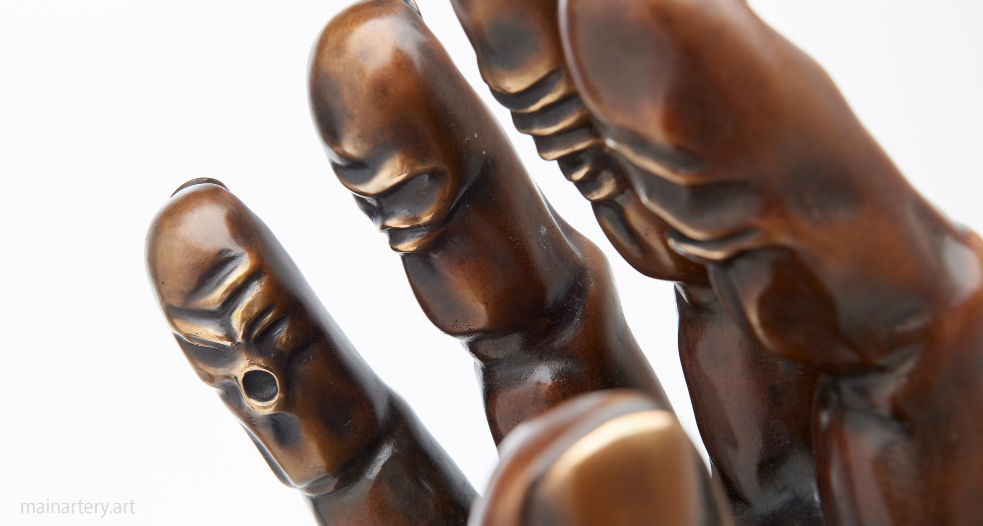 small patina face fingers sculpture image