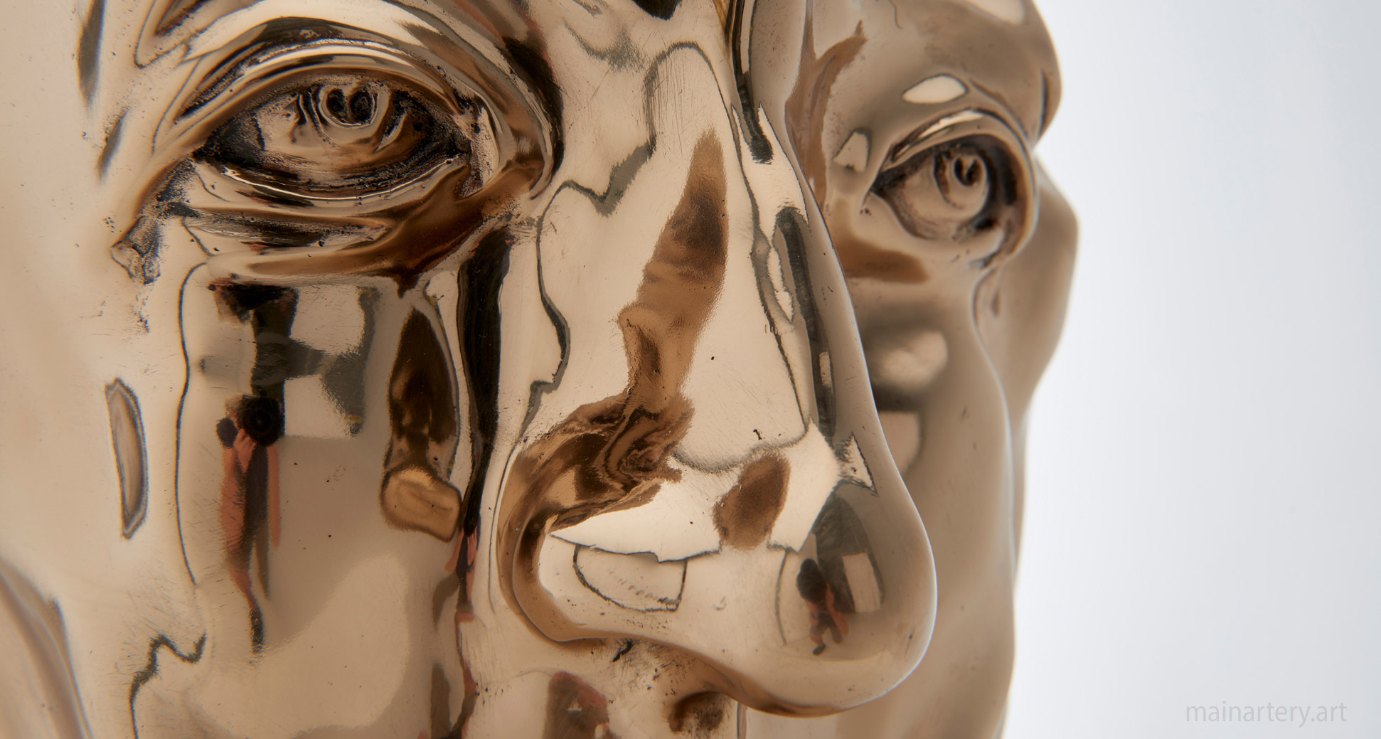 polished bronze hand face sculpture image