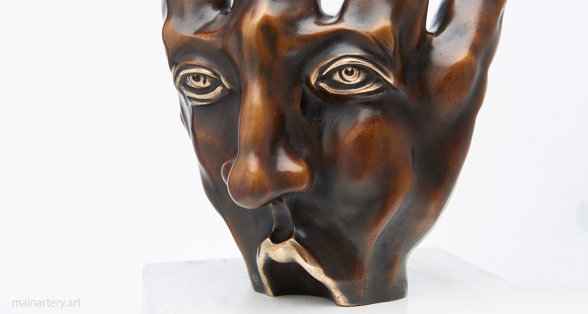 bronze patina contemporary face hand sculpture image